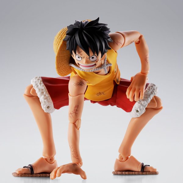 Monkey D. Luffy action figure in a low crouched battle stance with battle scars and a determined expression
