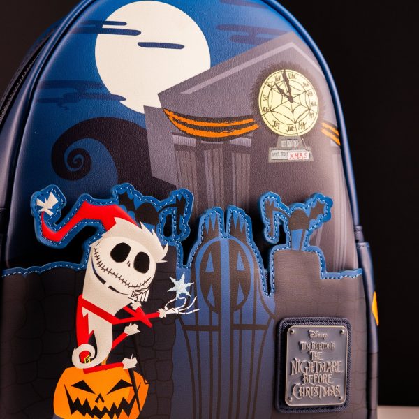 Loungefly Nightmare Before Christmas Santa Jack Graveyard Mini Backpack — close-up of Santa Jack standing on a jack-o’-lantern before the graveyard gates