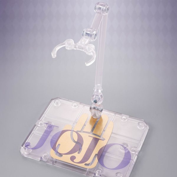 Clear plastic action figure stand with an articulated arm and a base featuring the JoJo logo and a gold hand