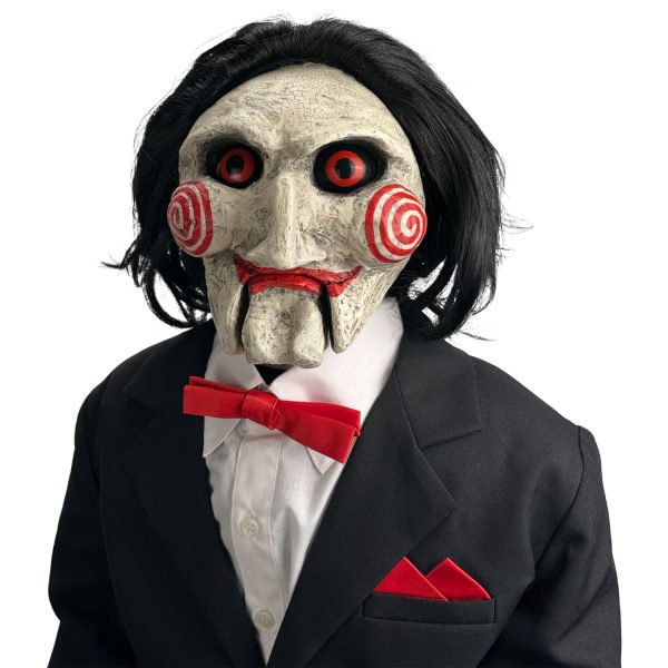 Billy the Puppet from Saw in a black suit, white shirt, and red bowtie with red spiral cheeks