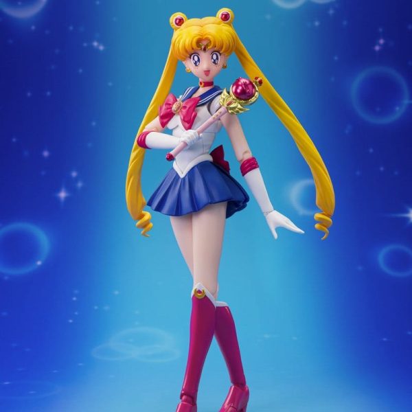 Sailor Moon action figure holding the Moon Stick against a blue background with sparkles