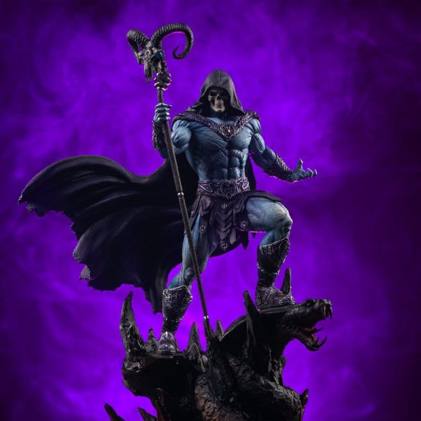 Detailed Skeletor statue with a blue muscular physique, skull face, and hood, holding the Havoc Staff on a rocky base