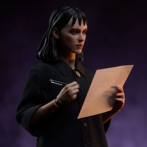 Collectible figure of Lydia Deetz from Beetlejuice holding a pen and paper