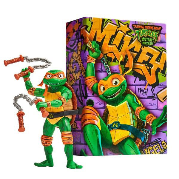 TMNT Mutant Mayhem Comic Con Michelangelo action figure with his nunchucks, beside the graffiti-print display box